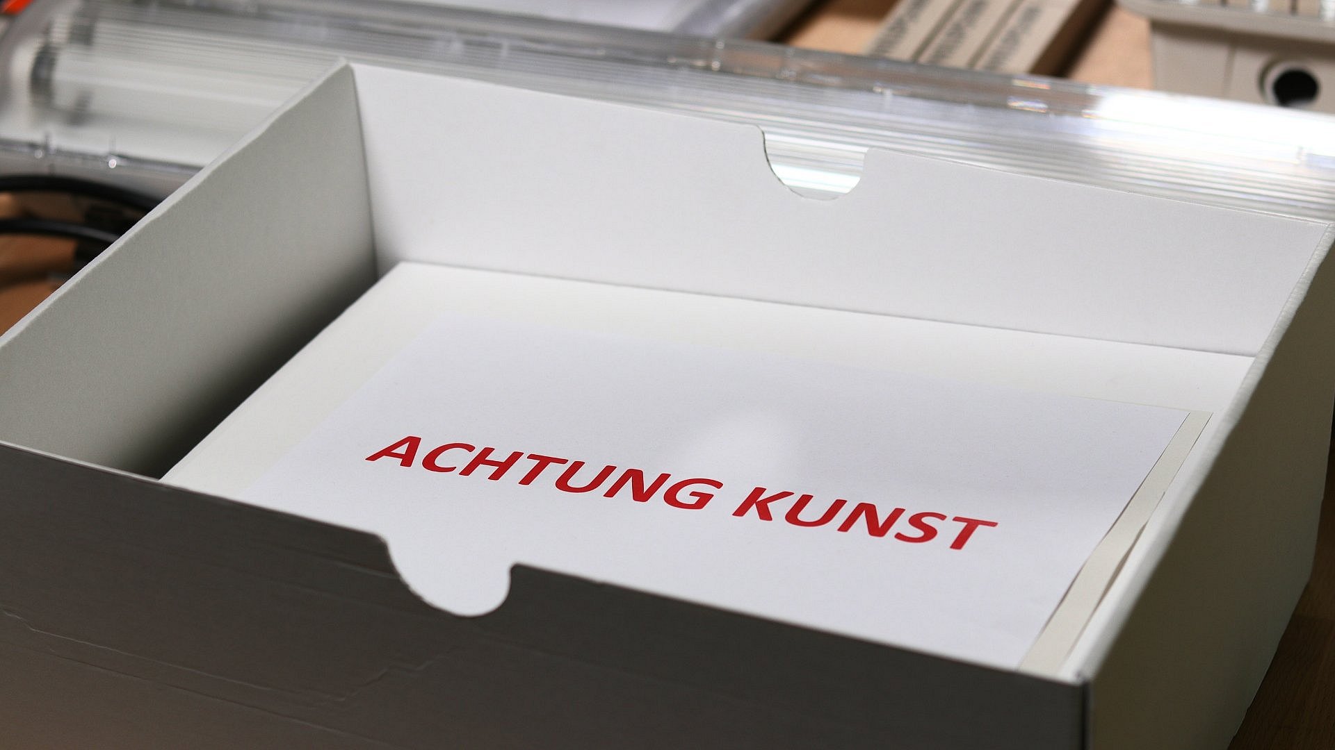 "Achung Kunst" in roter Schrift auf einem Zettel