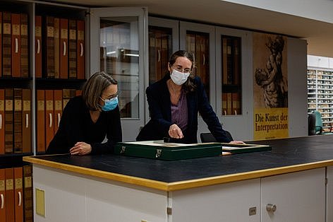 Zwei Frauen betrachten Kupferstiche