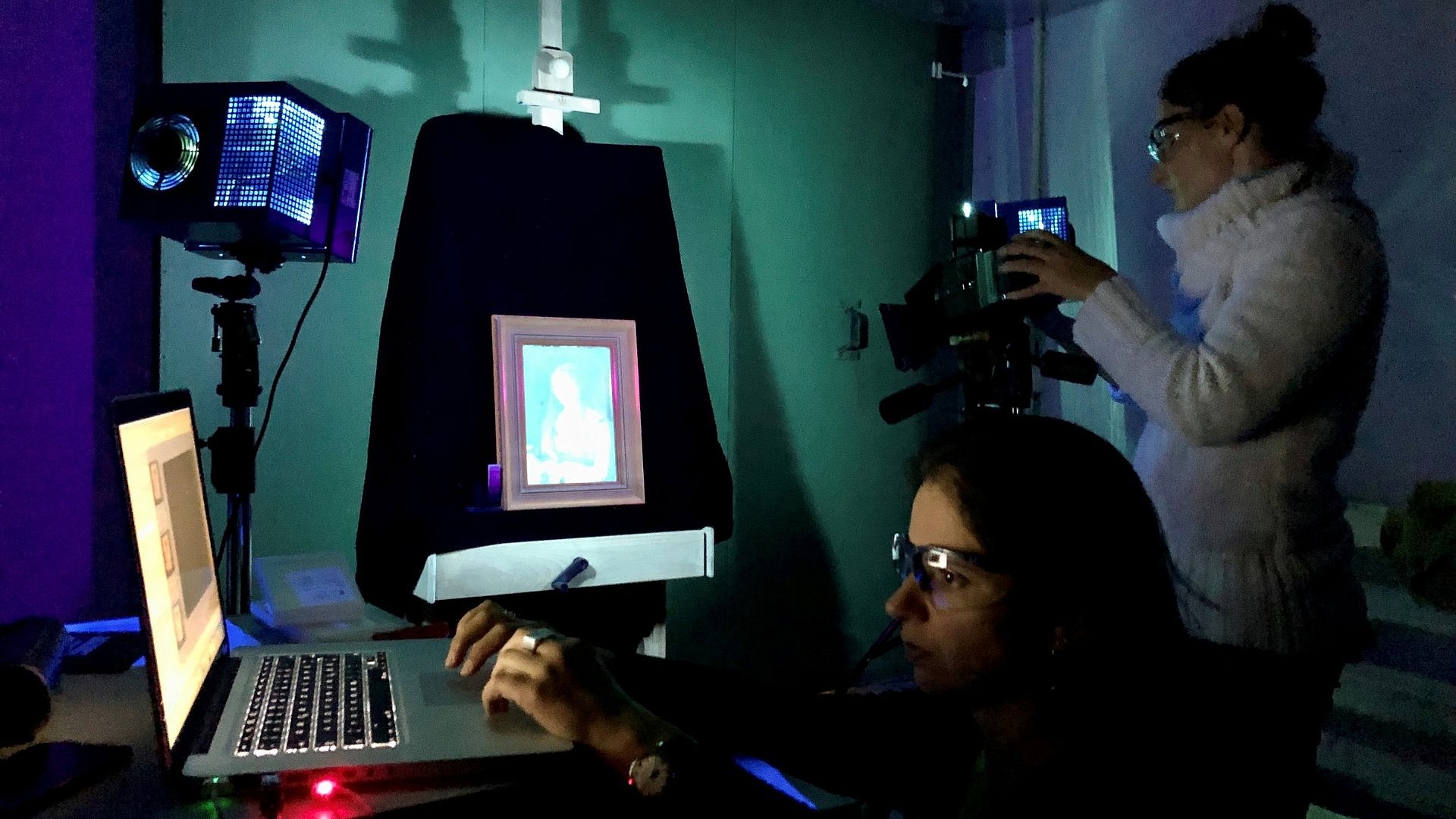 Two women are examining a work of art