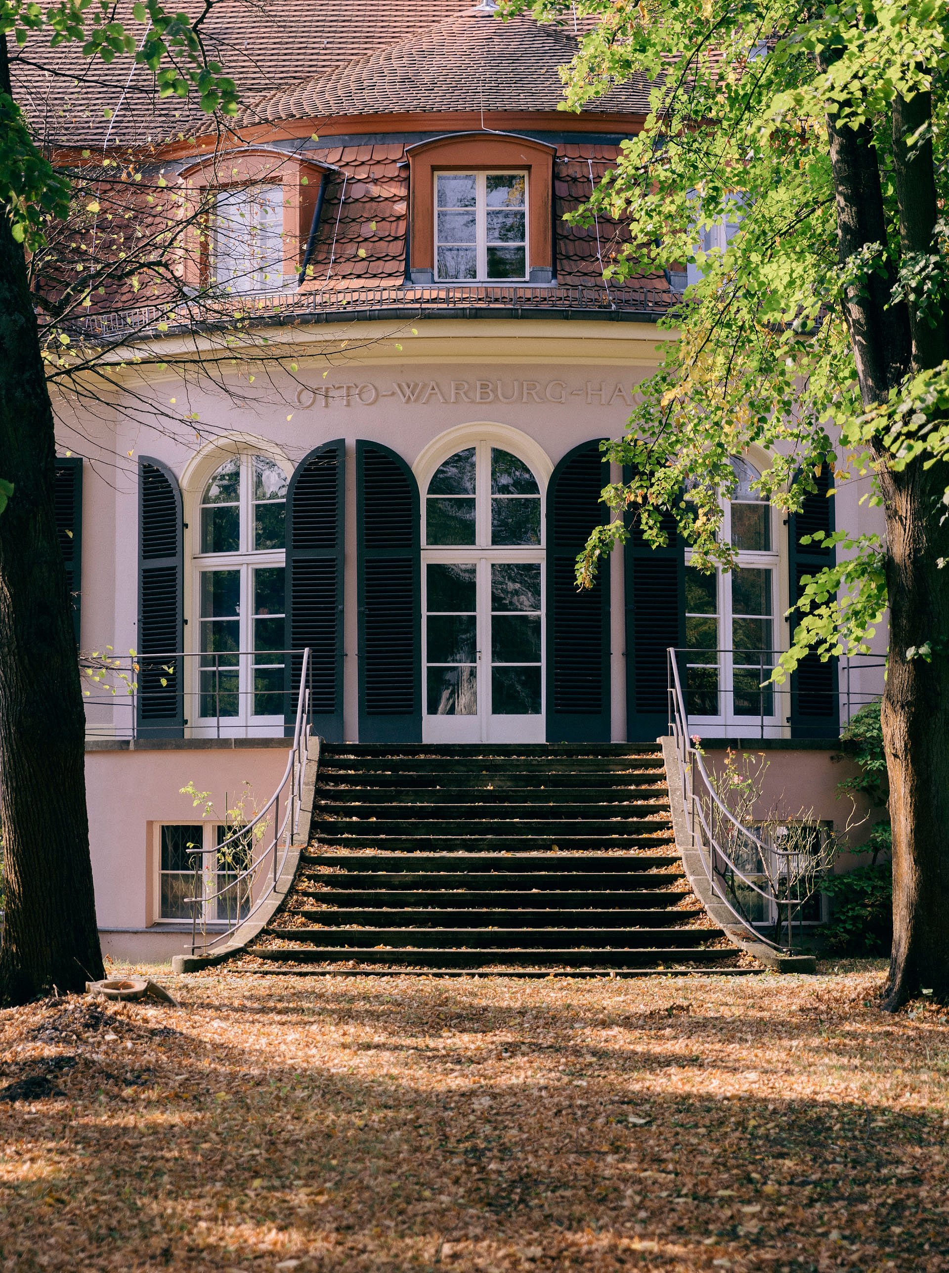 Herrenhäuslicher Eingang einer rosa Villa in herbstlicher Atmosphäre