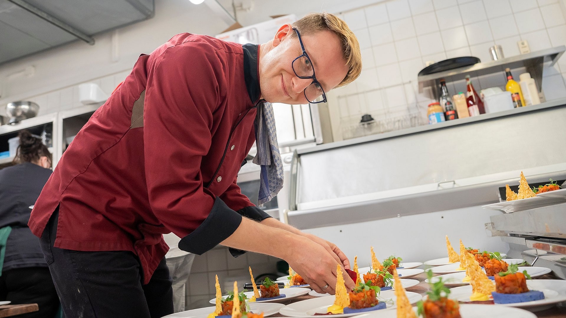 Ein Koch arrangiert eine Platte mit Hors d'oeuvres
