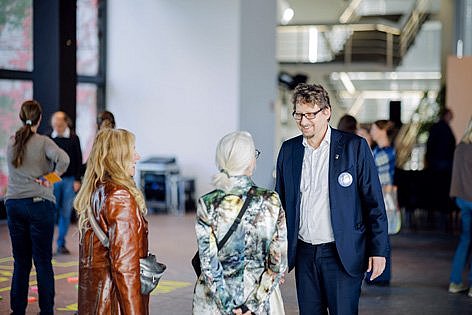 Ein Mann spricht mit zwei Frauen